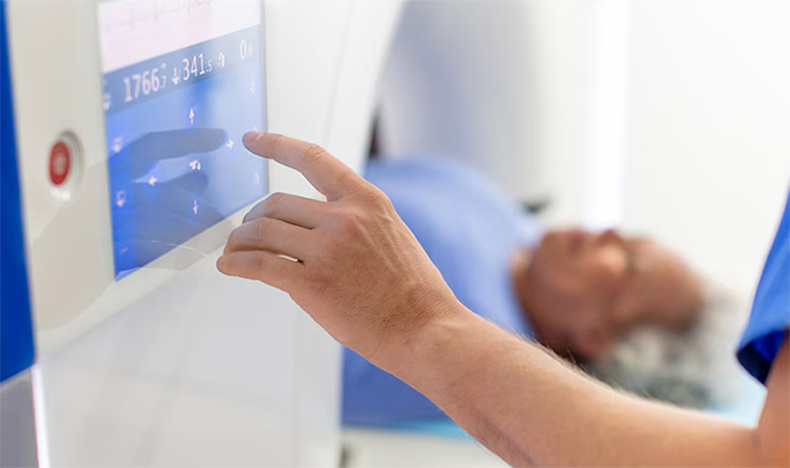 A radiology technician performing a CT scan