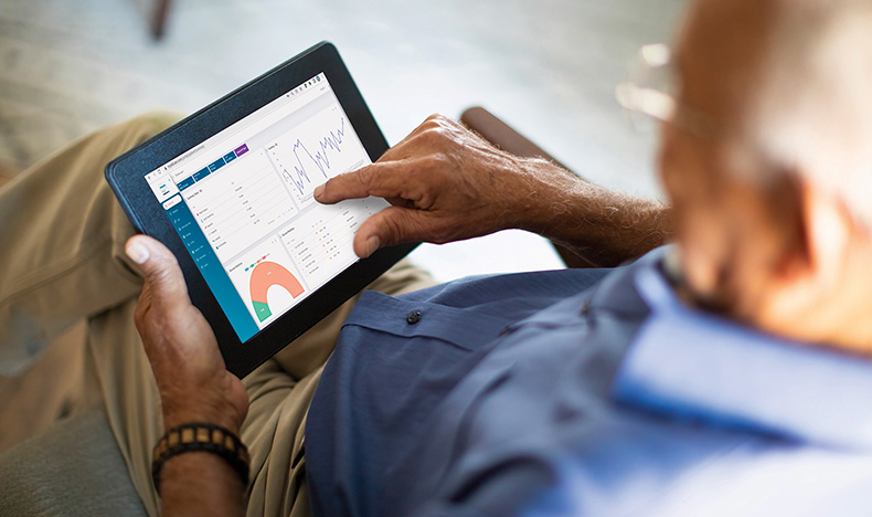 A patient monitoring health data on a tablet